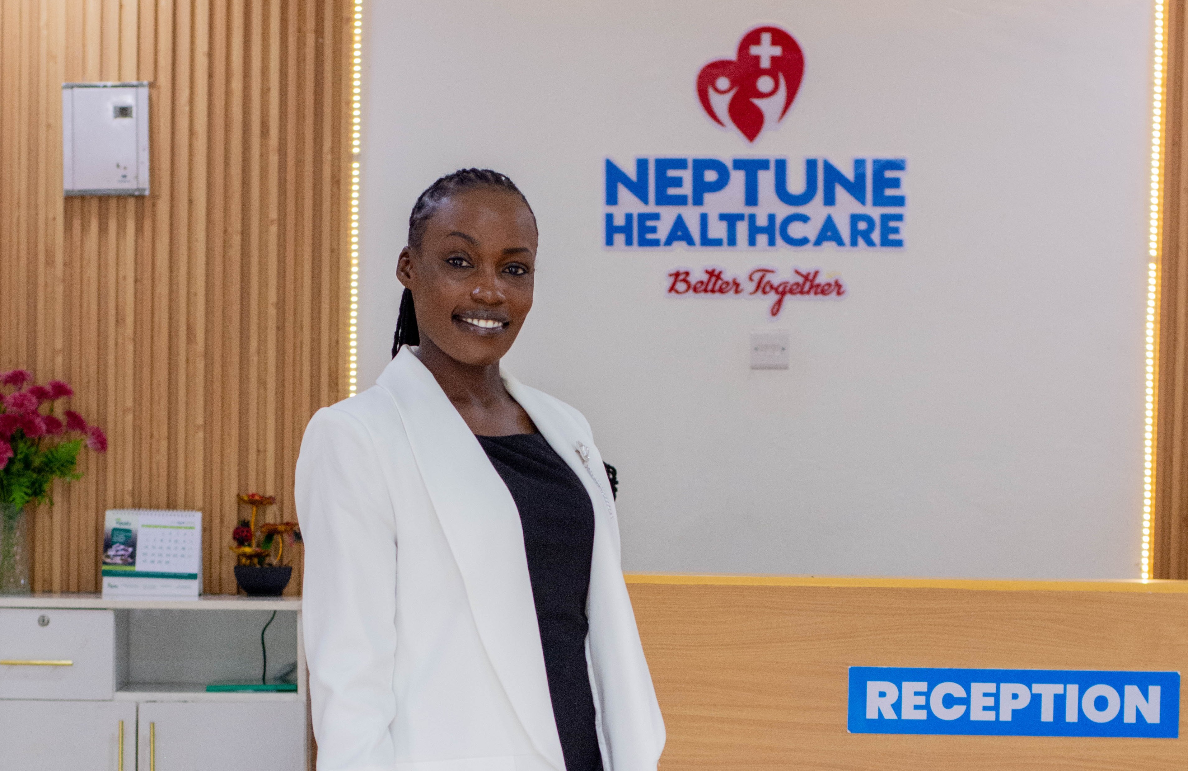 A Neptune Healthcare staff member welcoming visitors at reception